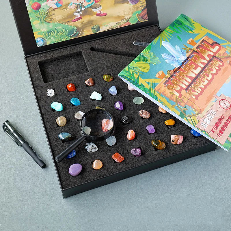 A gift box containing a collection of natural crystals and minerals, displayed alongside an open book.