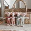 Four handmade mouse plush dolls wearing retro outfits standing in front of a woven basket