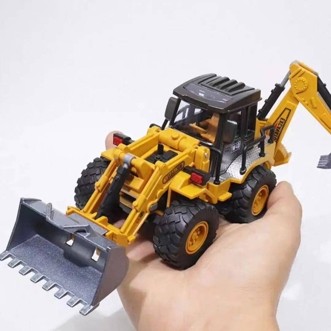 A hand holds a yellow diecast construction vehicle excavator with a black bucket and yellow tracks.