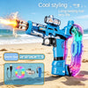 A blue electric water gun with a translucent purple grip and accessories lying on a sandy beach.