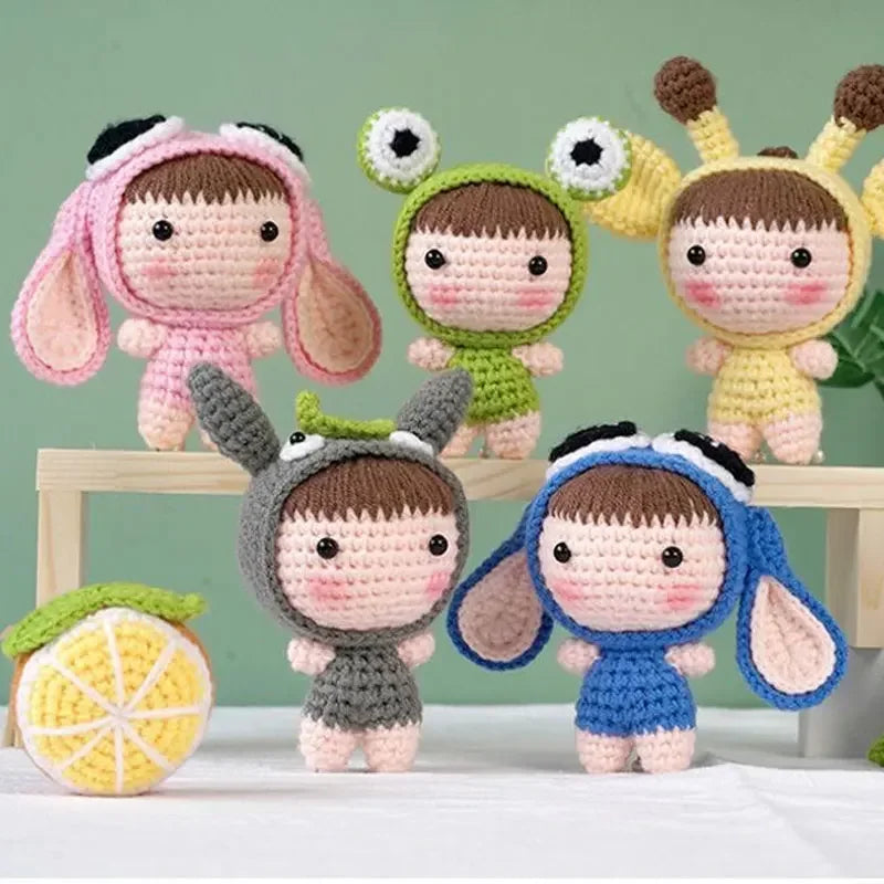 A collection of seven crocheted dolls in various colors and styles, including pink, green, yellow, and blue.