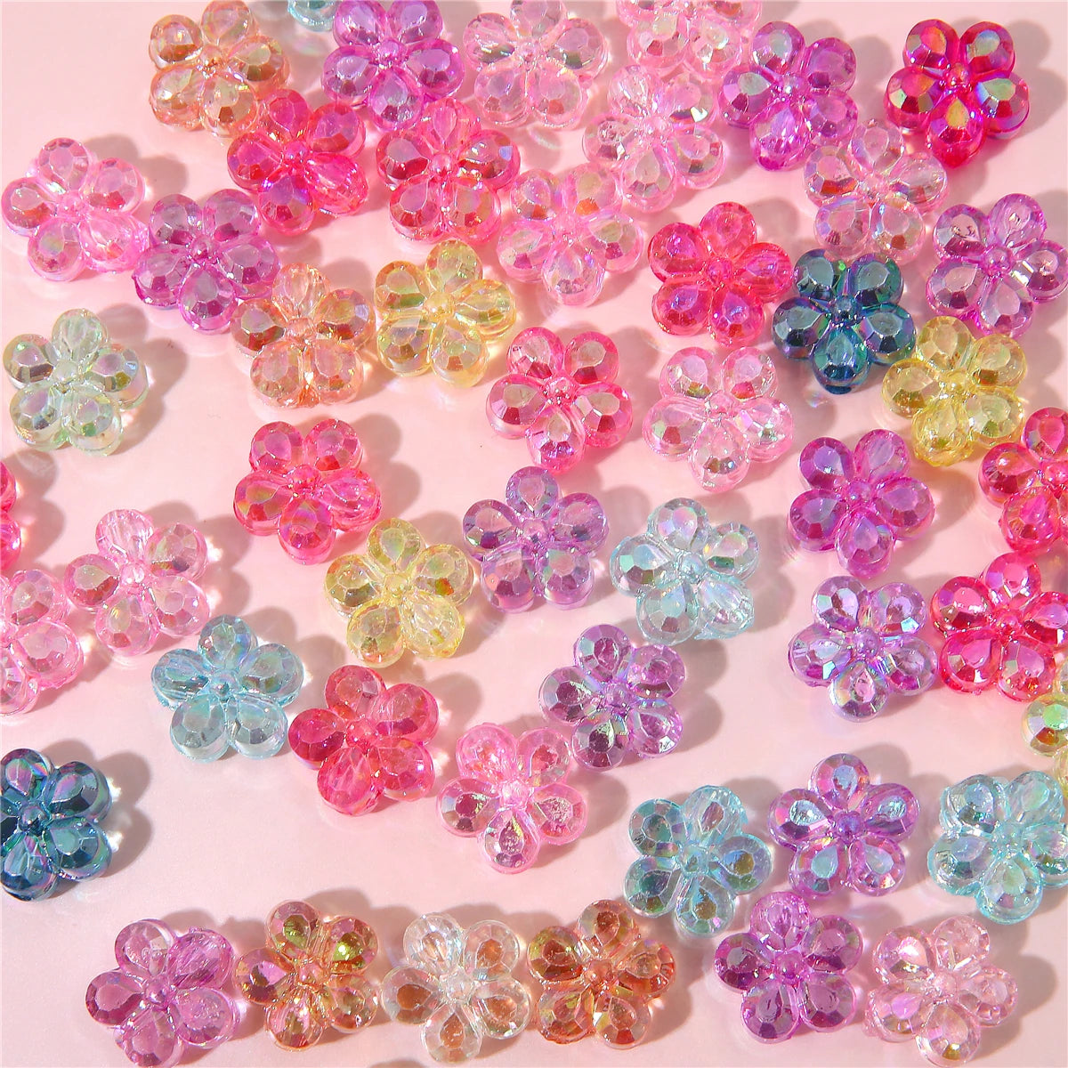 A collection of colorful acrylic flower beads in various shades of pink, purple, and blue for DIY jewelry making