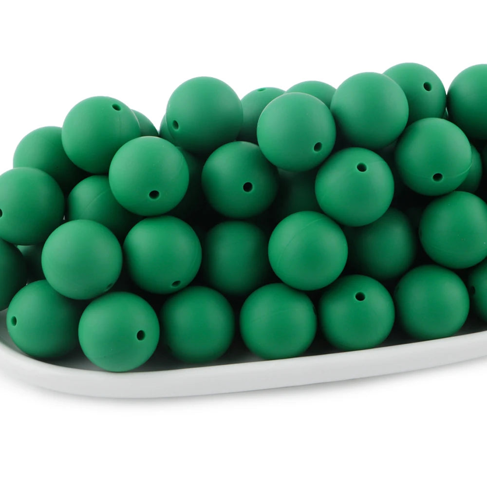 A pile of round, matte green silicone beads for jewelry making and DIY crafts.