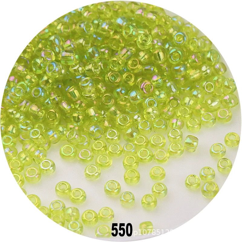 A pile of bright lime green round loose glass seed beads for jewelry making