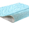 A close-up of light blue sparkling rhinestone adhesive tape in a rectangular roll.
