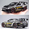 A black Nissan GTR R35 diecast model car with yellow accents and a rear spoiler is held in a hand.
