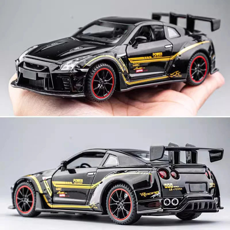 A black Nissan GTR R35 diecast model car with yellow accents and a rear spoiler is held in a hand.