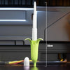 A white 3D gravity banana katana stress relief toy is shown vertically against a dark background.