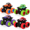 A set of four black and orange pull-back stunt cars with large wheels and green accents.