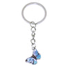 Silver chain with a butterfly charm used as a keychain for bags and accessories