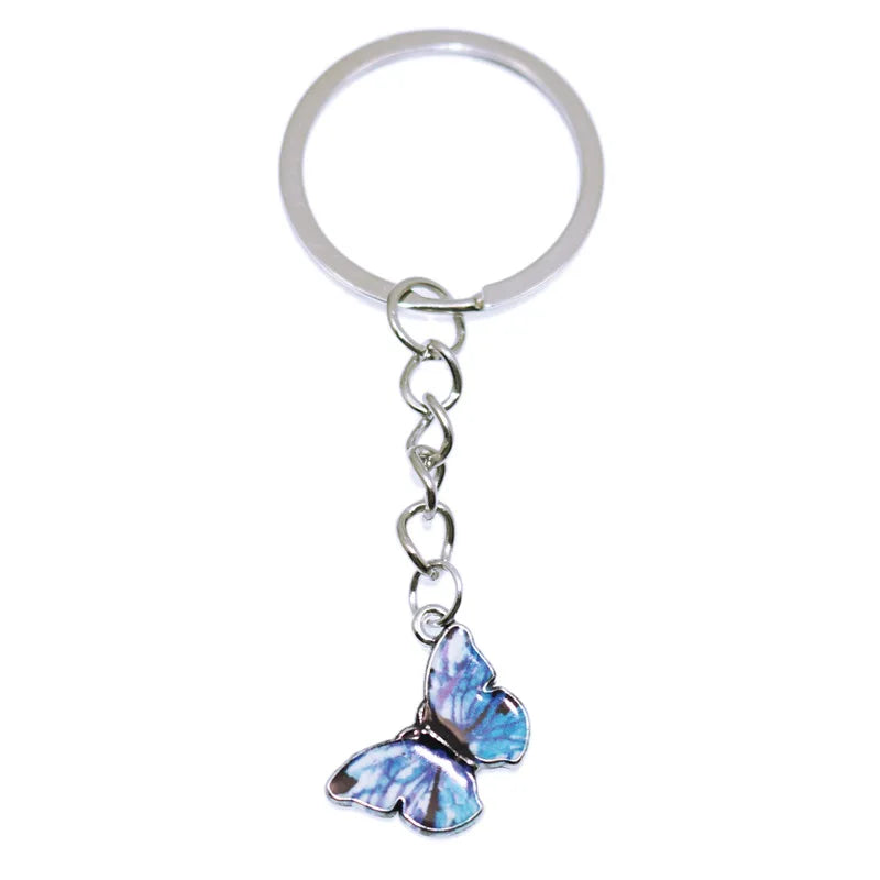 Silver chain with a butterfly charm used as a keychain for bags and accessories