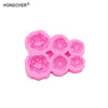 A set of pink silicone molds shaped like peonies and roses for resin, jewelry, and baking.