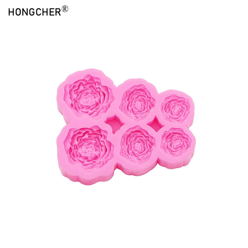 A set of pink silicone molds shaped like peonies and roses for resin, jewelry, and baking.