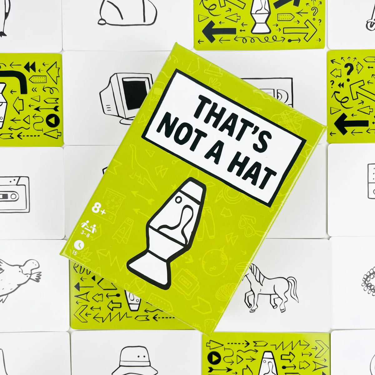 A yellow game box titled That's Not a Hat featuring line drawings and game components.