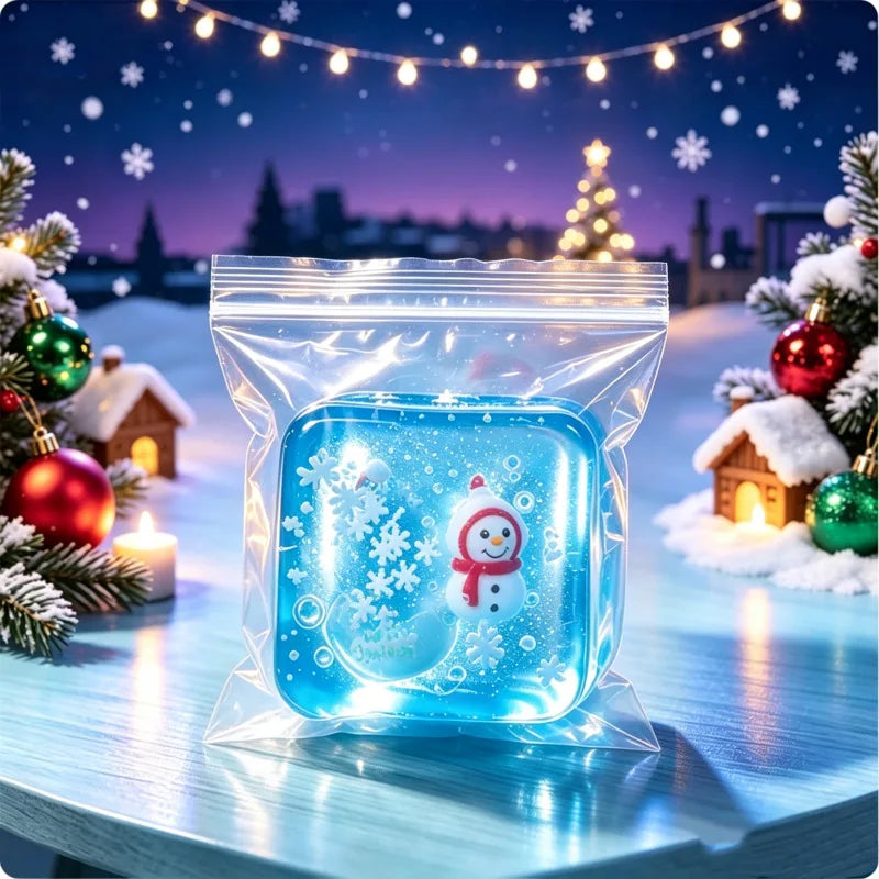 A clear blue fidget cube shaped like a snowman, pumpkin, and ghost is displayed in a plastic bag with holiday decorations.