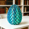 Un œuf de dragon bleu vibrant pour la relaxation, posé sur une table blanche devant une étagère.