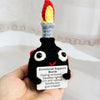Handmade crochet bomb doll with a colorful top and an encouragement card