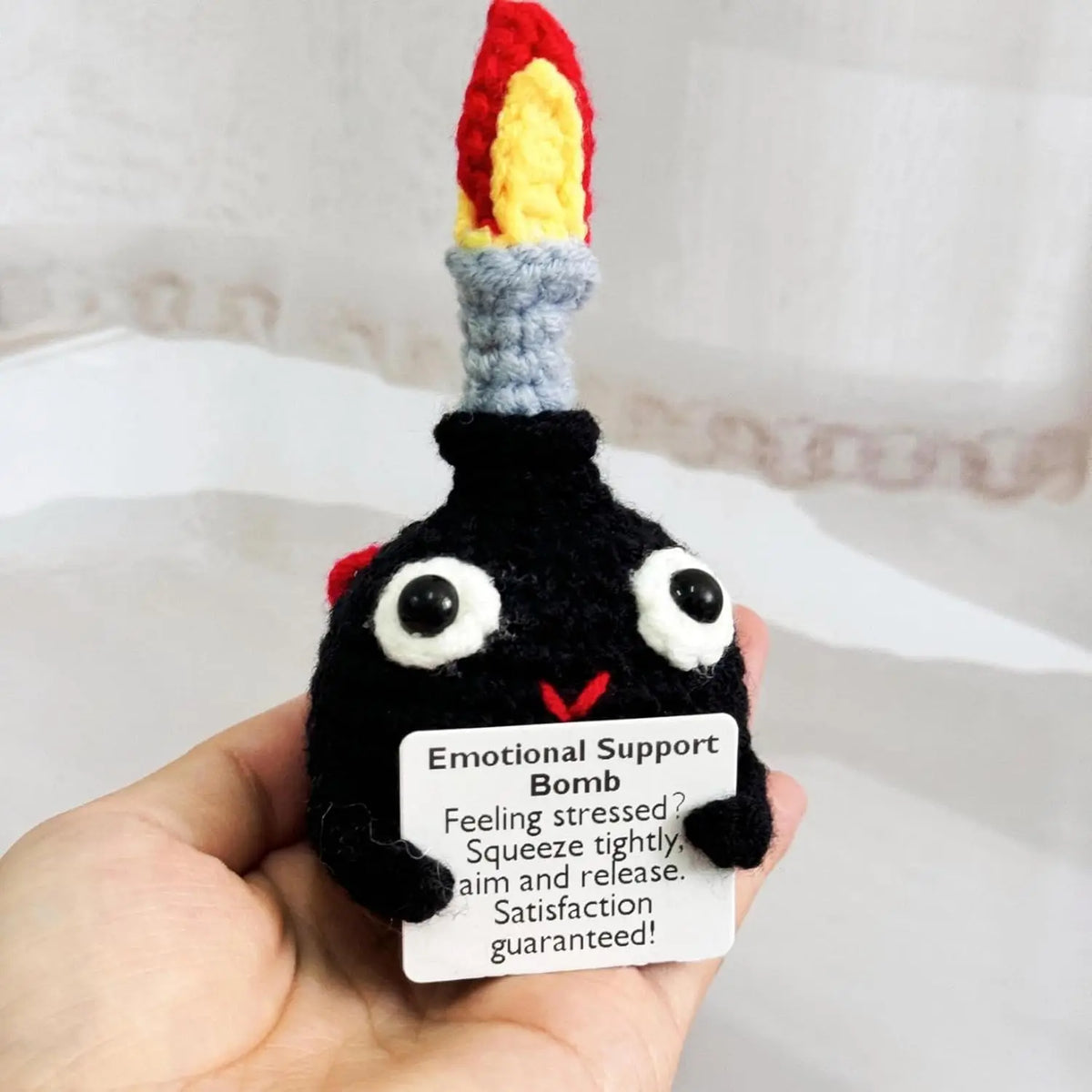 Handmade crochet bomb doll with a colorful top and an encouragement card