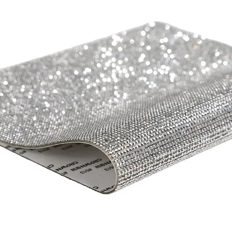 Silver sparkling rhinestone adhesive tape rolled up for DIY crafts and decor