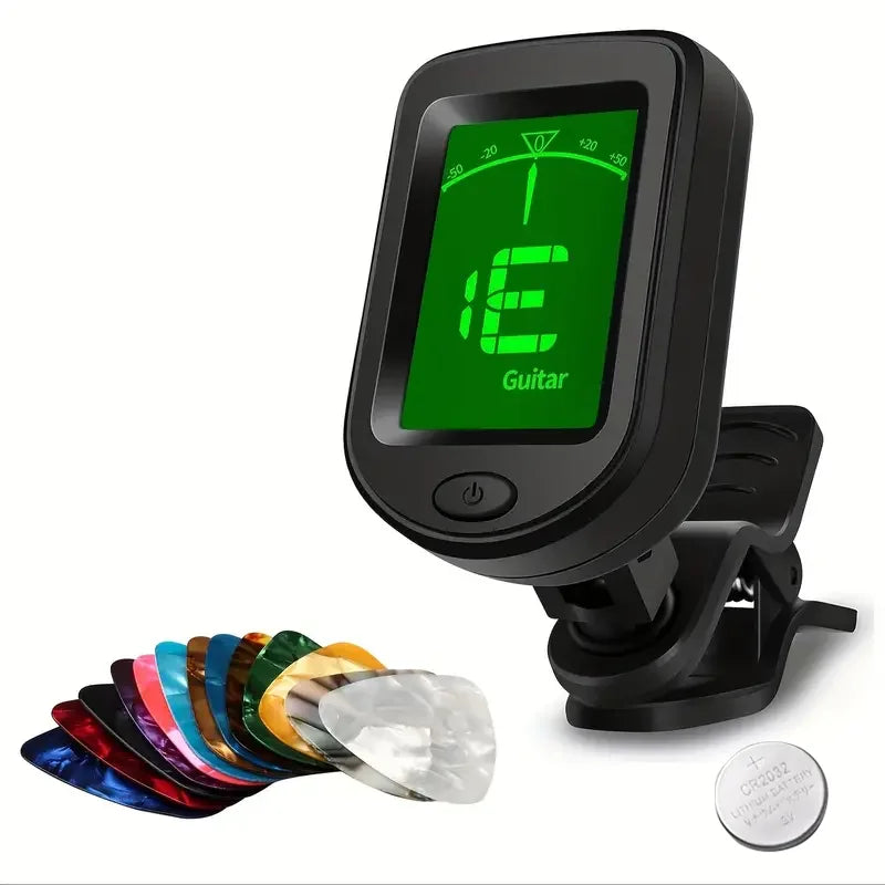 A black clip-on digital tuner with a green display and a set of ten guitar picks.