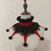 Black and red ruffled collar accessory displayed on a mannequin neck.