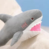 A gray and pink plush toy depicting a killer whale and a great white shark.