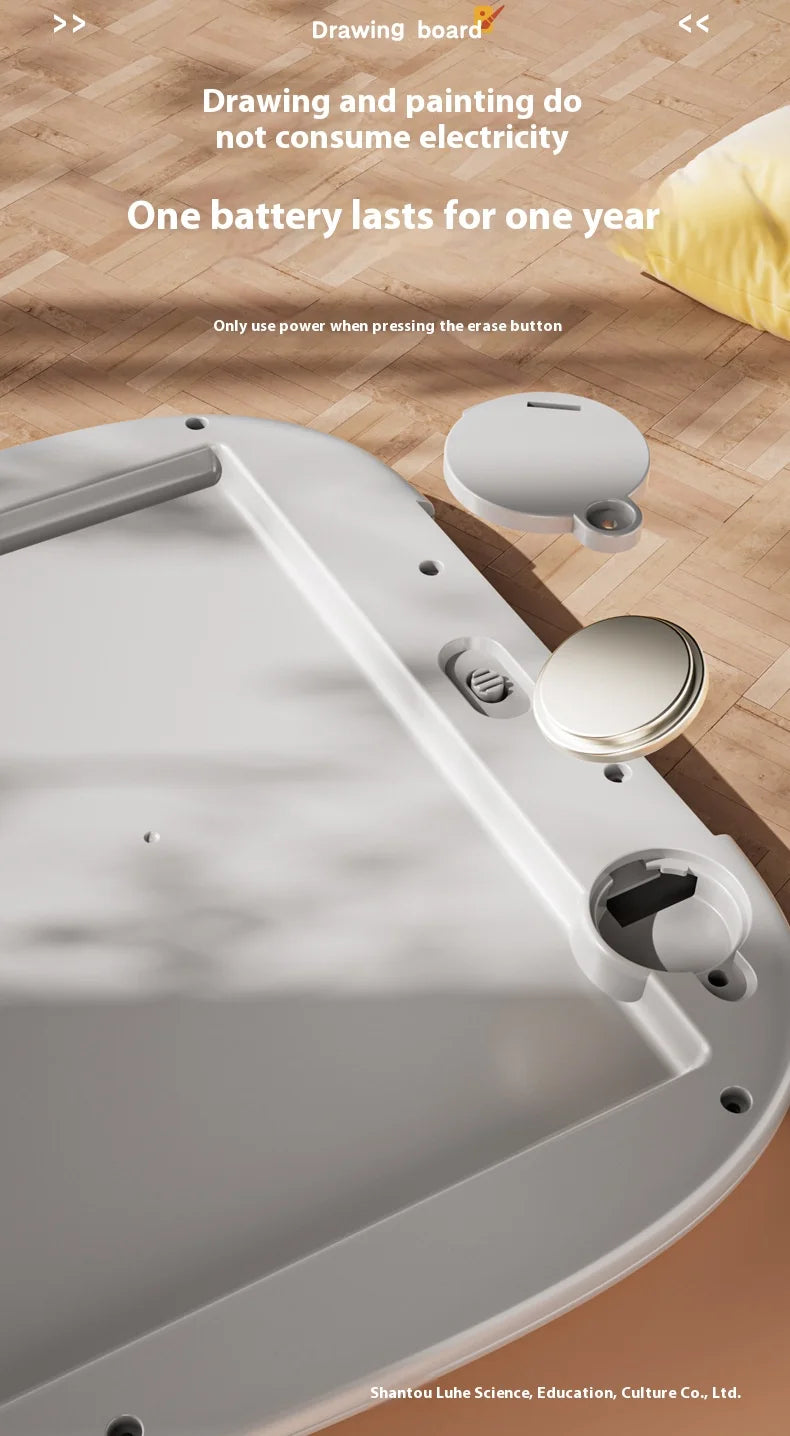 A white LCD writing tablet is shown on a wooden surface, demonstrating its drawing and painting capabilities.