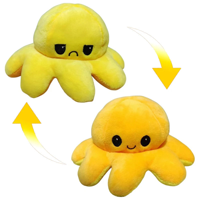 A pair of yellow, double-sided flip octopus plush toys, one frowning and one smiling.