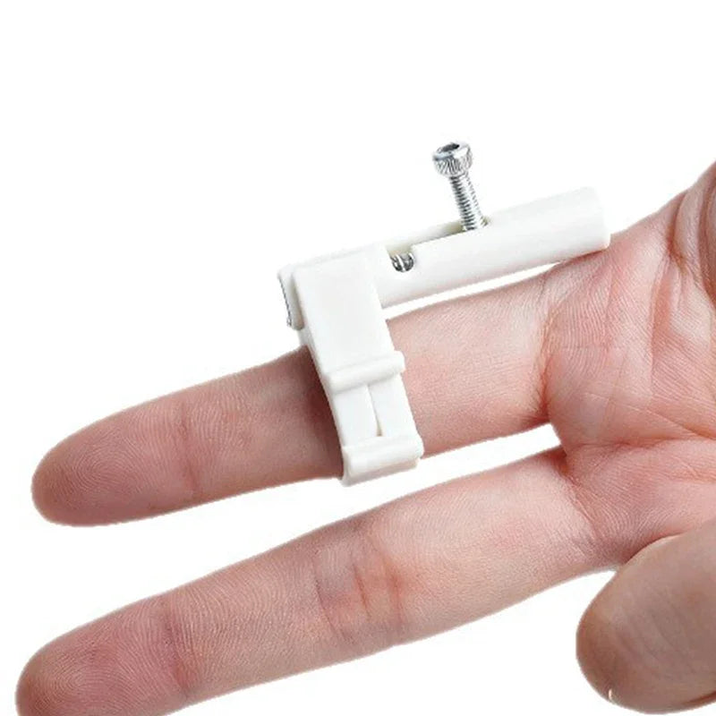 A hand holds a white finger ring launcher fidget toy with a silver screw top.