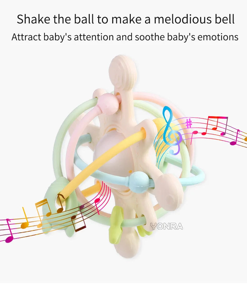 A silicone rattle and sensory ball with colorful rings and musical notes for soothing a baby.
