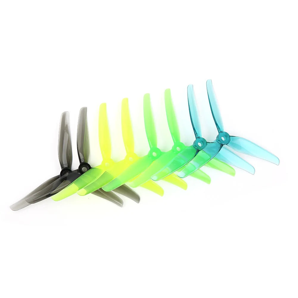 A set of high-efficiency drone propellers in various colors including black, yellow, and blue.