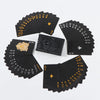A set of elegant black and gold waterproof playing cards arranged on a white background.