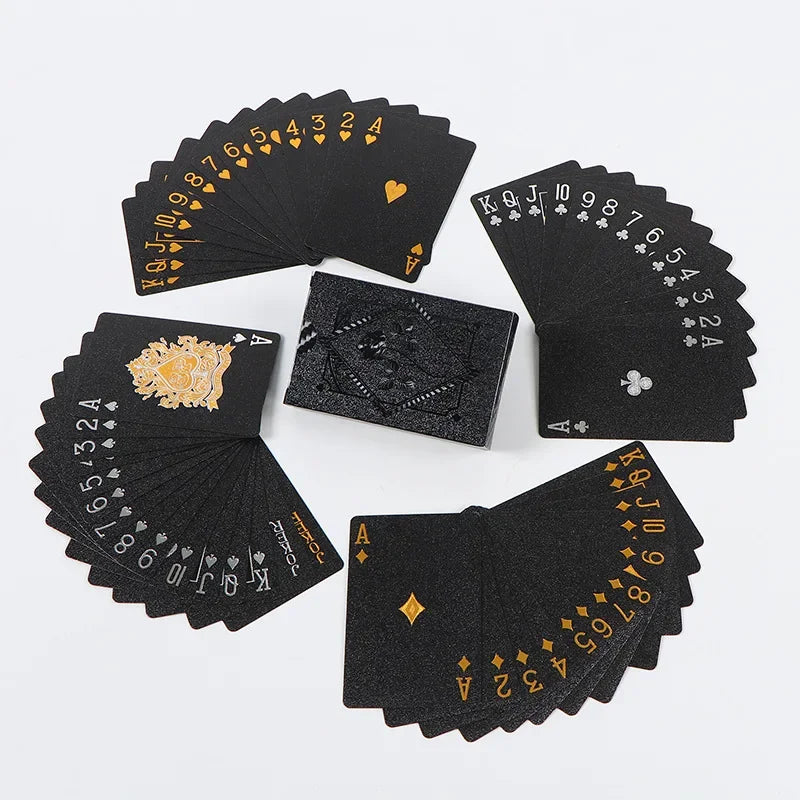 A set of elegant black and gold waterproof playing cards arranged on a white background.