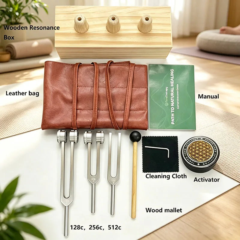 A set of sound healing tuning forks, including a wooden resonance box, leather bag, and various tools like a manual and activ