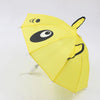 A yellow umbrella shaped like a bear face with black eyes and features, used as a mini doll accessory.