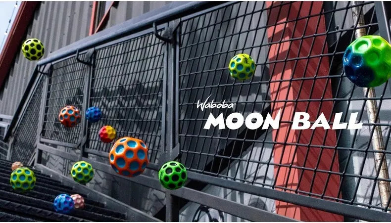 A green moon ball is visible against a dark metal fence with a red background.