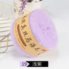 A ball of purple mohair blended yarn is displayed next to a gold wire rack.
