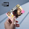 A hand holds a pink and yellow card slot sticker featuring a stylized face and text on a light gray background.