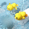 A yellow duck bath toy is visible in clear blue water.
