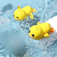 A yellow duck bath toy is visible in clear blue water.