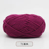 A ball of magenta pre-dyed milk cotton yarn used for knitting and crochet.