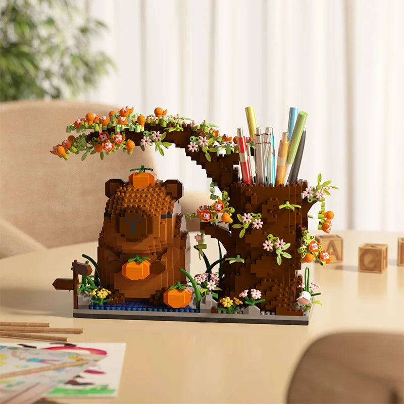 A capybara building block desk organizer featuring a wooden bear body and foliage used to hold pens and pencils.