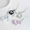 A collection of beaded wing cross phone lanyards and keychains featuring clear and purple beads.