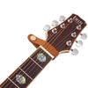 A close-up view of a brown leather guitar strap button with a silver metal fastener.