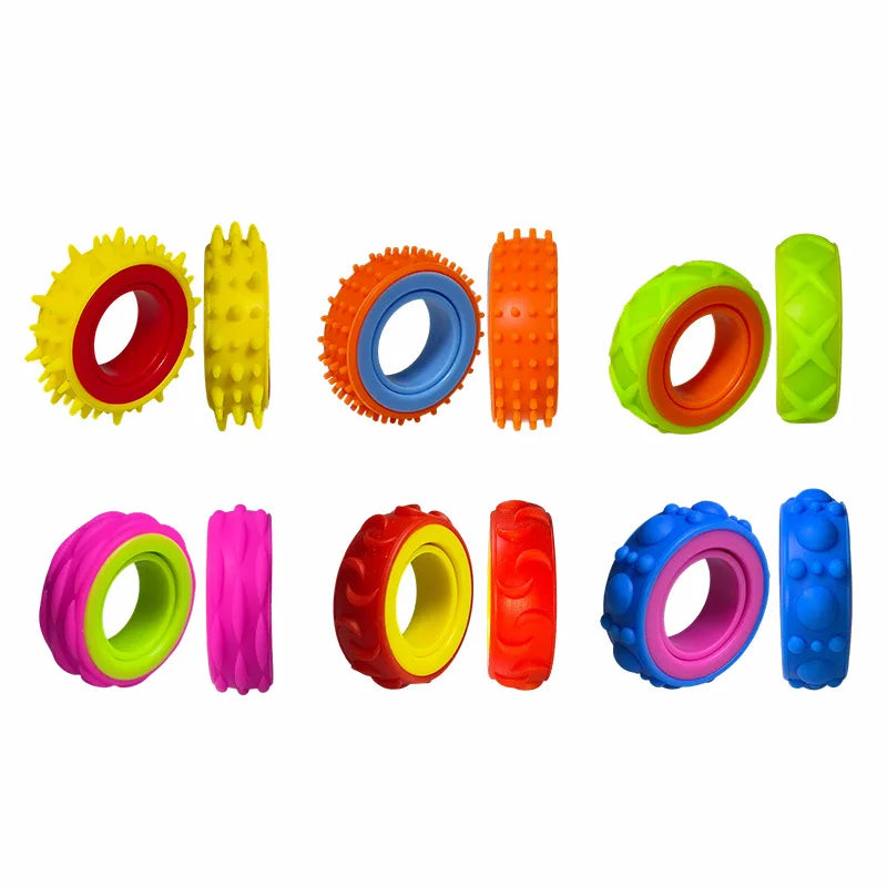 A collection of colorful sensory fidget rings in yellow, orange, green, pink, red, and blue.