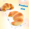 A golden croissant is shown being held, with measurements indicating its size.
