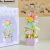 A miniature flower bouquet building block set featuring a large yellow and pink daisy flower.