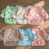A collection of full-sleeve waterproof baby bibs featuring various cute cartoon designs in pink, green, and blue.