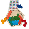 A wooden tangram puzzle set featuring various colored geometric shapes arranged in a hexagonal pattern.