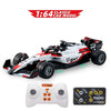 A white and red 1:64 scale RC drift car model with wheels and a controller.